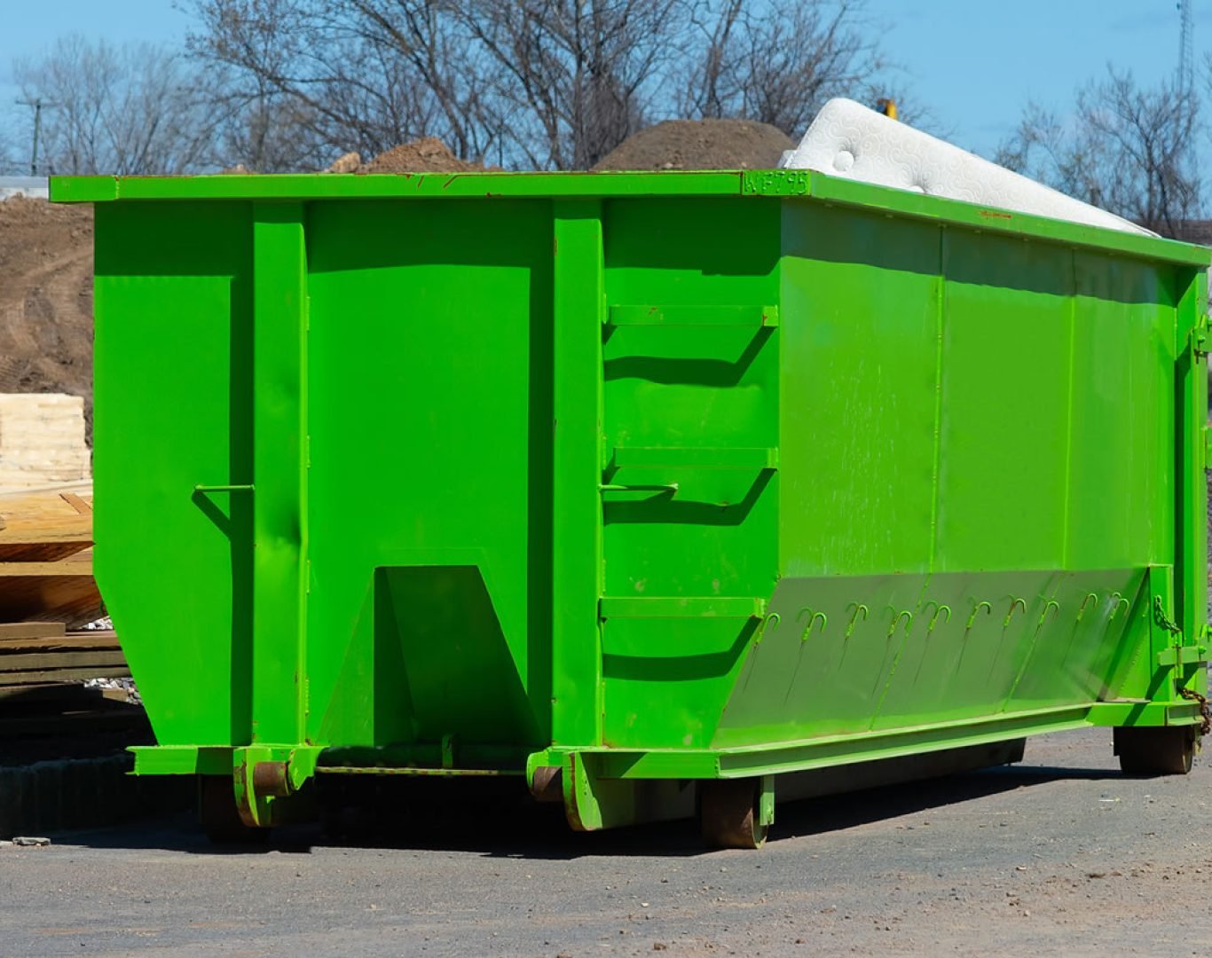 Roll off dumpster being delivered to a construction site in Kingston, Jamaica